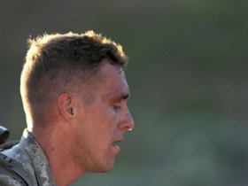 Specialist Cruser Barnes of the Hawaii Guard takes a short breather during the ruck march event of the 2015 National Guard Best Warrior Competition at Camp Williams, UT. Barnes was named Guard Soldier of the Year. —Photo by SFC Jon Soucy