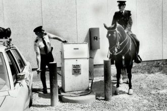 Watching Const. Paul Dewsnap gas up his patrol car,  Const. James Barger and his mare,  Joan,  prove that horses are more fuel-efficient than autos.